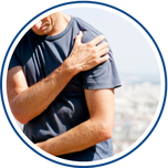 Man with shoulder pain holds his shoulder.