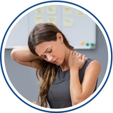 Woman having neck pain holding her neck.
